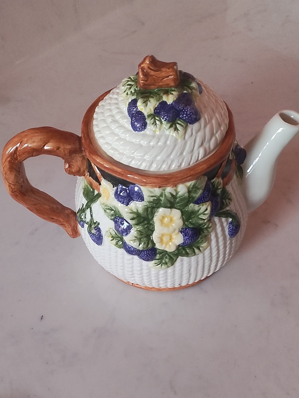 Hand-Painted Ceramic White Teapot with Purple Berry and Green Leaf Accents.